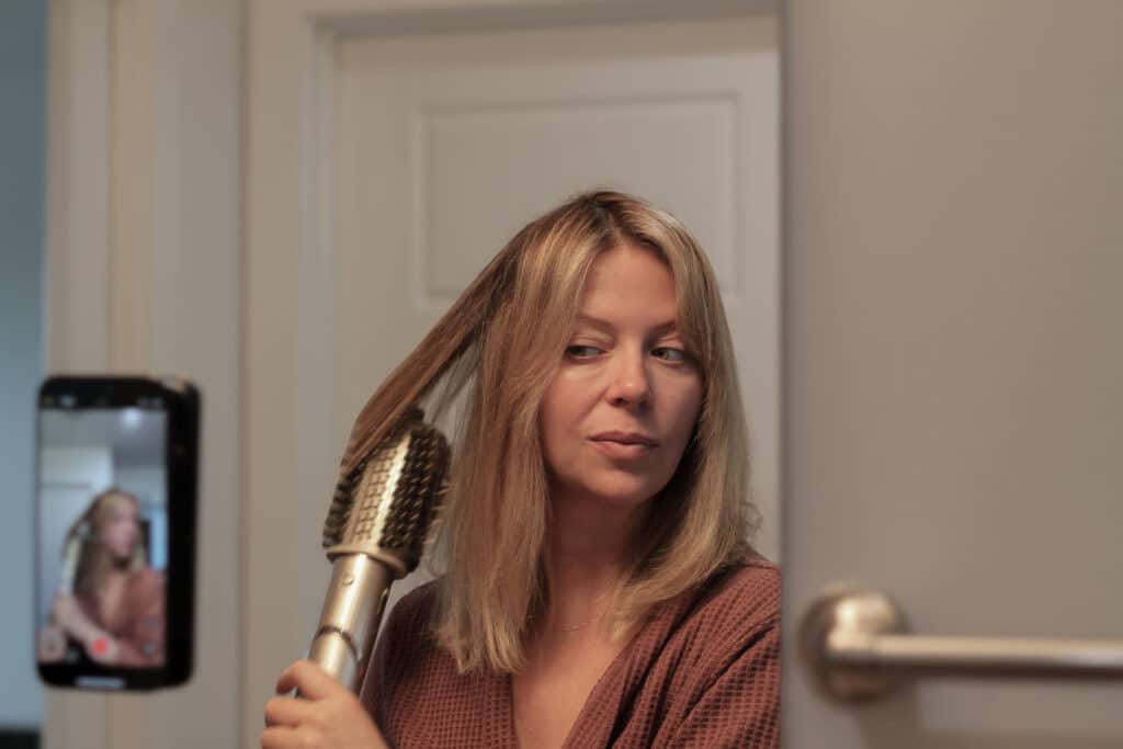 Photo 2025-07-17 11 02 18 AM - House Work Sarah from GoCleanCo styles her shoulder-length blonde hair with a round brush hair dryer.
