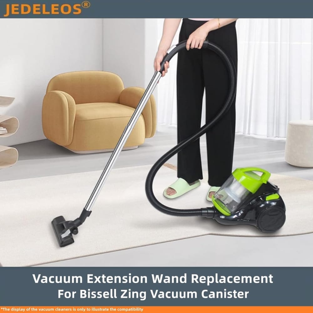 Person uses a green and black canister vacuum with a long wand to clean a light-colored carpet in a modern living room.