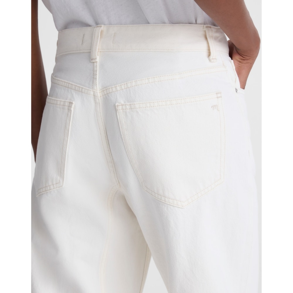 Rear view of white denim jeans showing two back pockets, belt loops, and subtle beige stitching.
