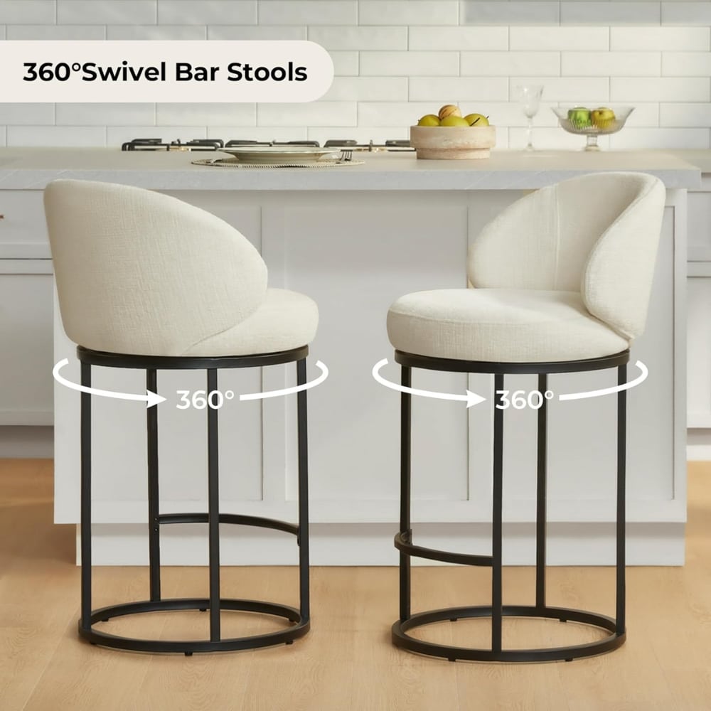 Two cream upholstered bar stools with circular black metal bases in a bright kitchen, shown swiveling 360° (indicating their rotation).