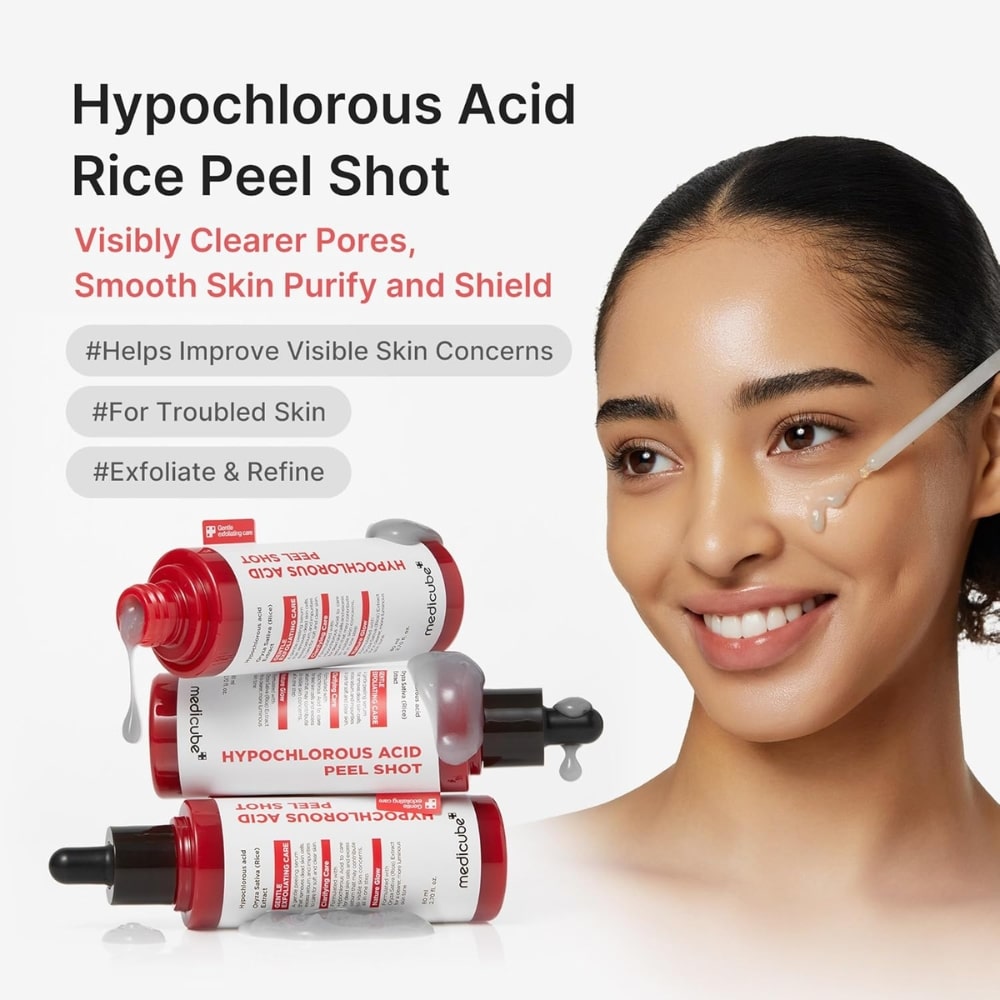 Woman applying facial serum with a dropper beside stacked bottles labeled Hypochlorous Acid Peel Shot.