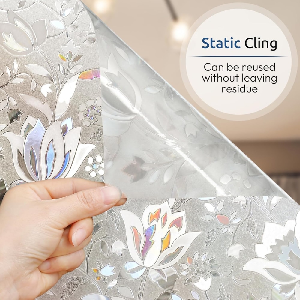 Hand peeling back a sheet of silver floral wallpaper showing its reusable static-cling backing with a label that says 'Static Cling can be reused without leaving residue'