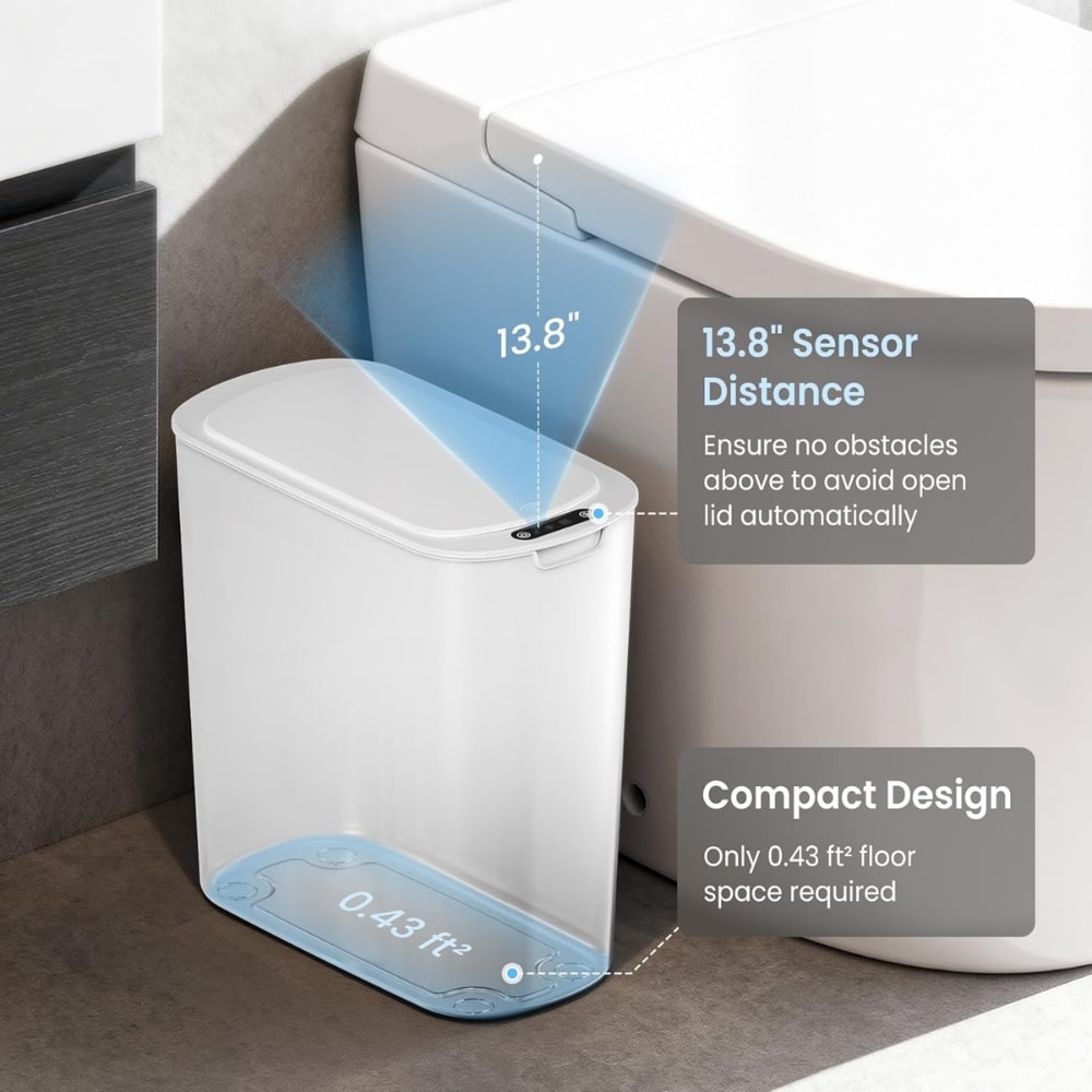 Compact white sensor-activated bathroom trash can with a 13.8-inch opening distance and a 0.43 ft² floor space footprint beside a toilet.