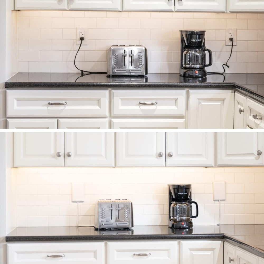 White kitchen counter with a toaster and coffee maker on dark granite, white cabinets and a tiled backsplash.