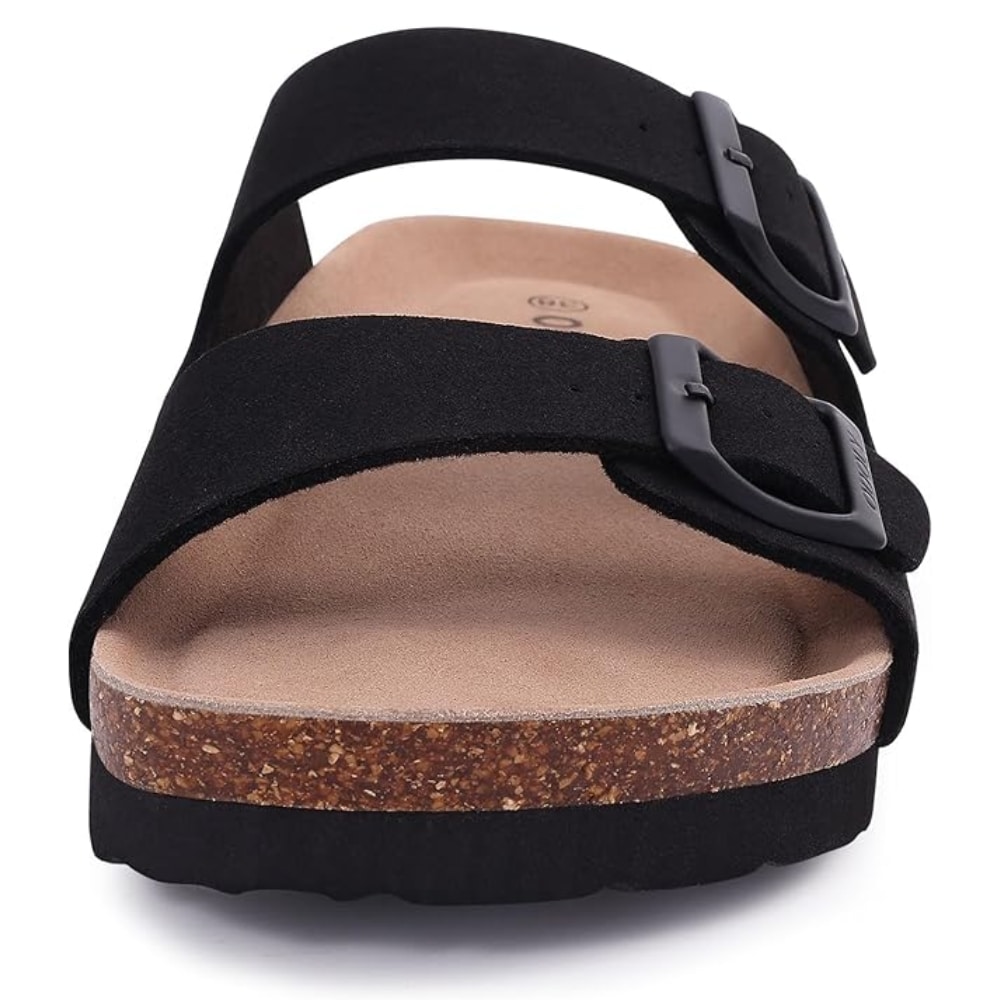 Close-up of a black double-strap sandal with buckles, cork midsole, and contoured footbed.