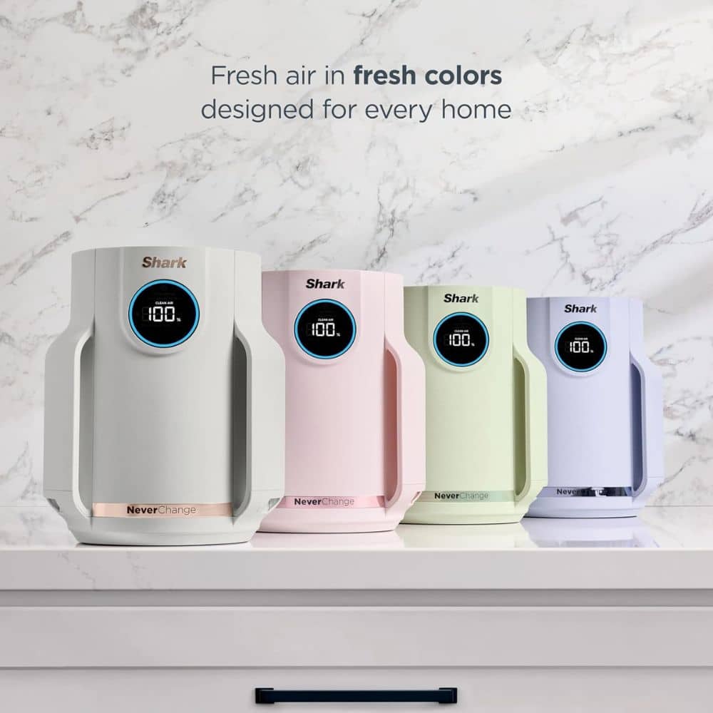 Pastel-colored Shark air purifiers on a countertop with the slogan 'Fresh air in fresh colors designed for every home' above them, showcasing variety in a modern kitchen setting.
