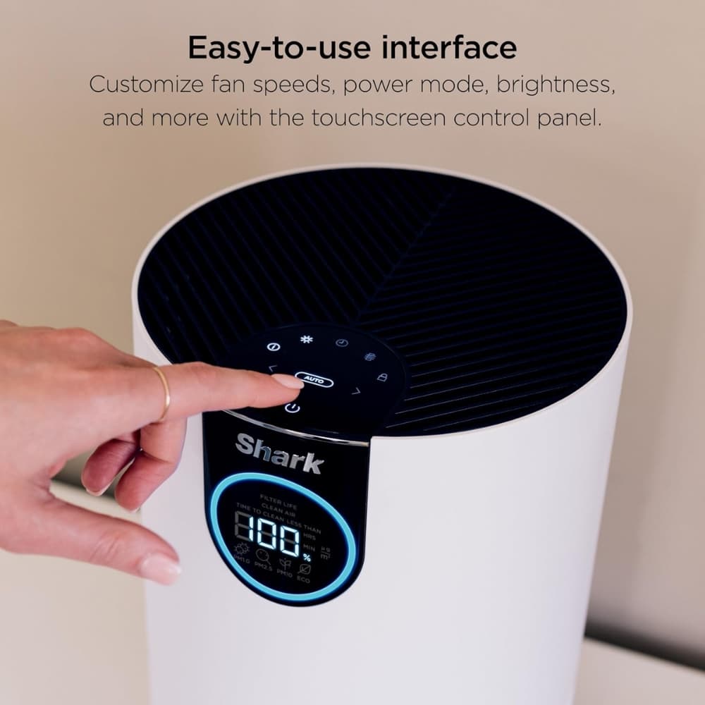 Person pressing the Auto button on the Shark air purifier's touchscreen control panel, showing an easy-to-use interface.