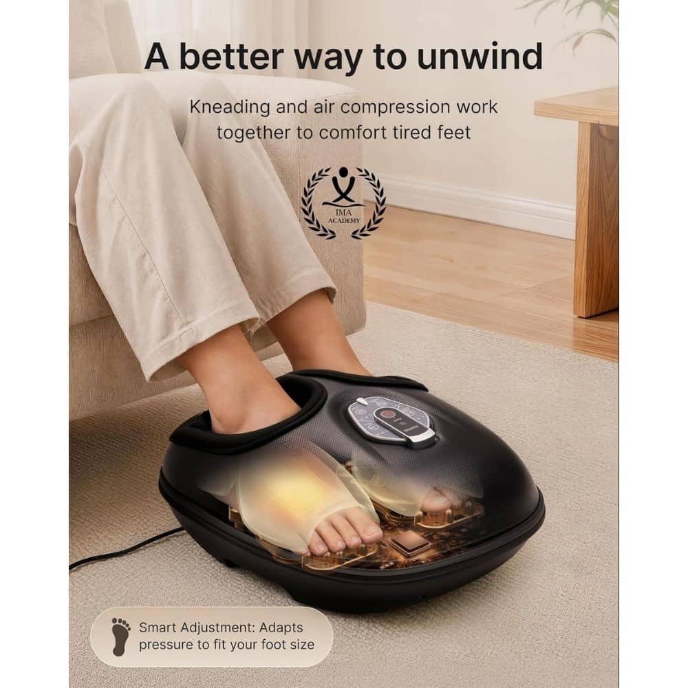 Person's feet in a padded foot massager with a dial on top, resting on a beige rug; device appears to knead and compress feet.