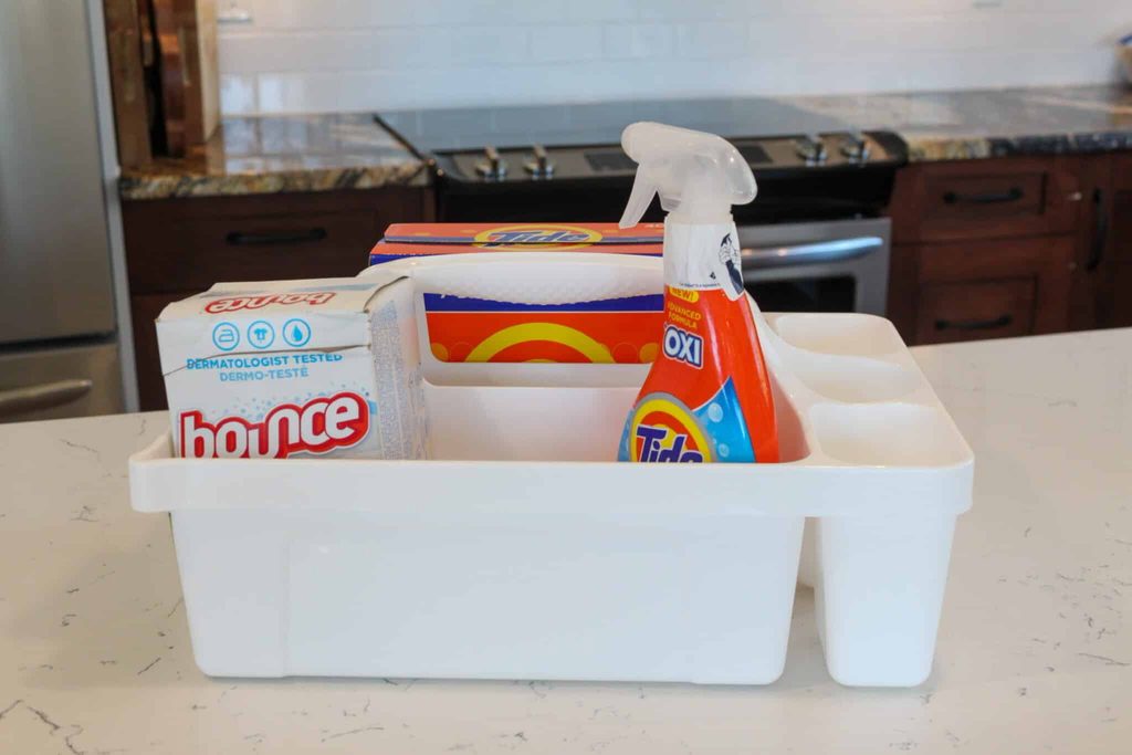 2CAFC77B-AC9D-4CF5-873F-E27AD28B0406-Sara-Bellamy-2048x1365-1 - House Work A college dorm laundry kit with stain remover, dryer sheets, and laundry detergent is shown.