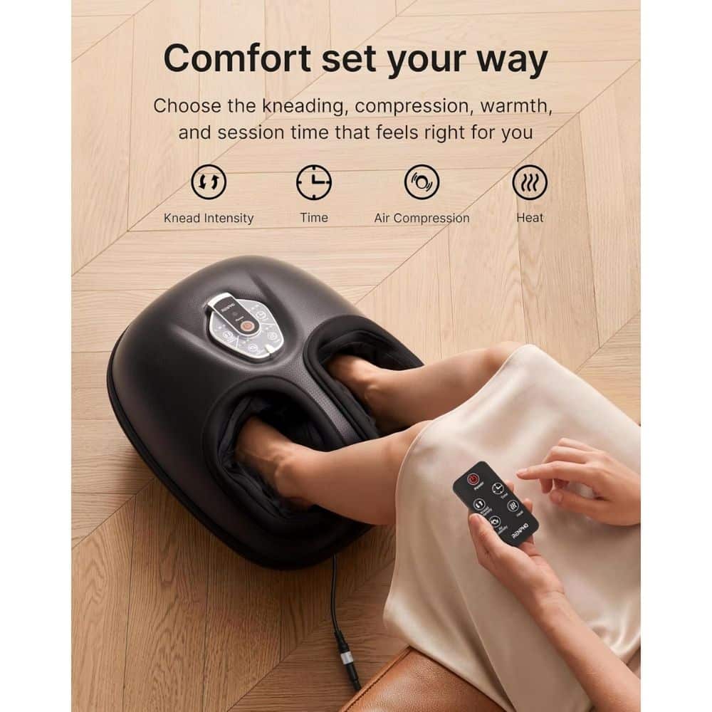Foot massager with feet inside, managed by a remote control to adjust kneading, time, air compression, and heat on a wooden floor.
