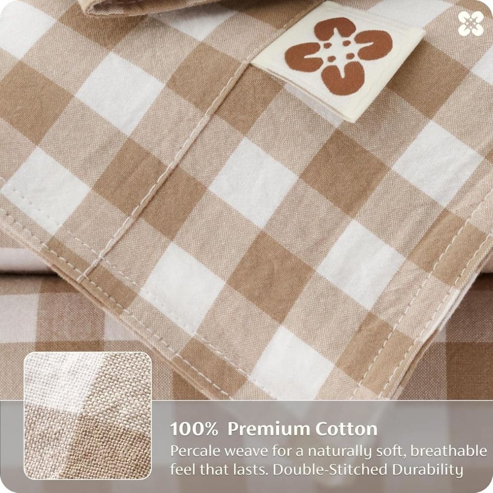 Close-up of beige-and-white gingham cotton fabric with a small sample swatch and a tag mentioning 100% Premium Cotton.
