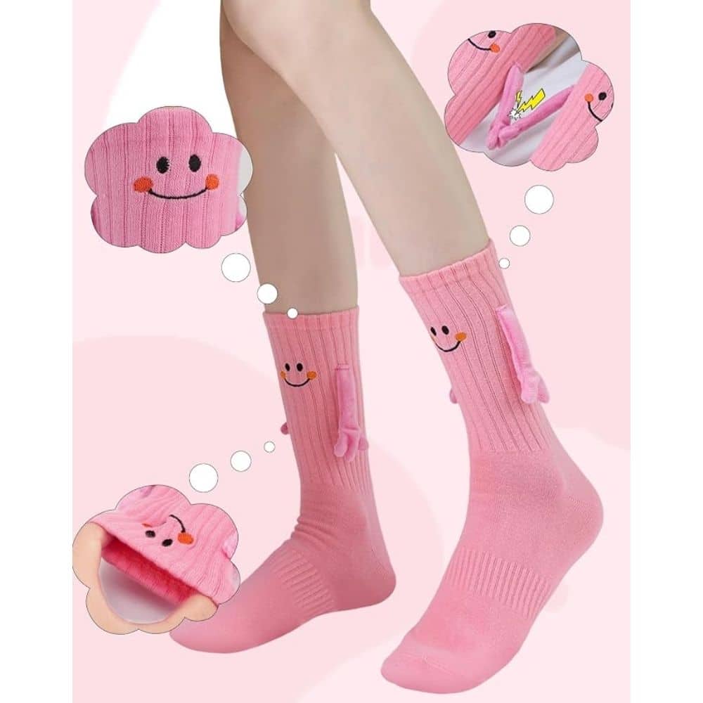Pink knee-high socks for kids with cute smiling cloud patches and small plush tails on the sides.