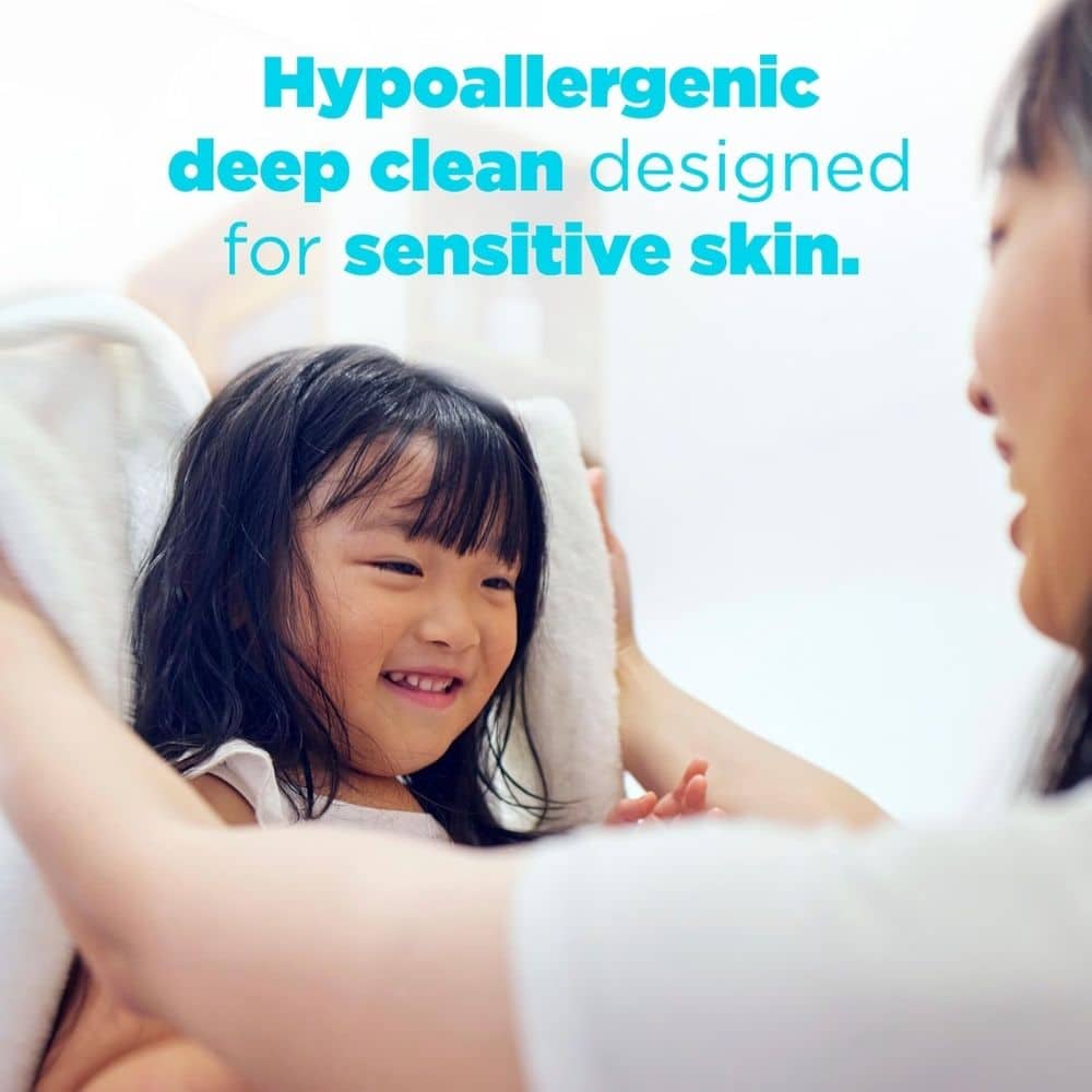 Smiling young girl being dried with a towel; blue headline reads 'Hypoallergenic deep clean designed for sensitive skin'.