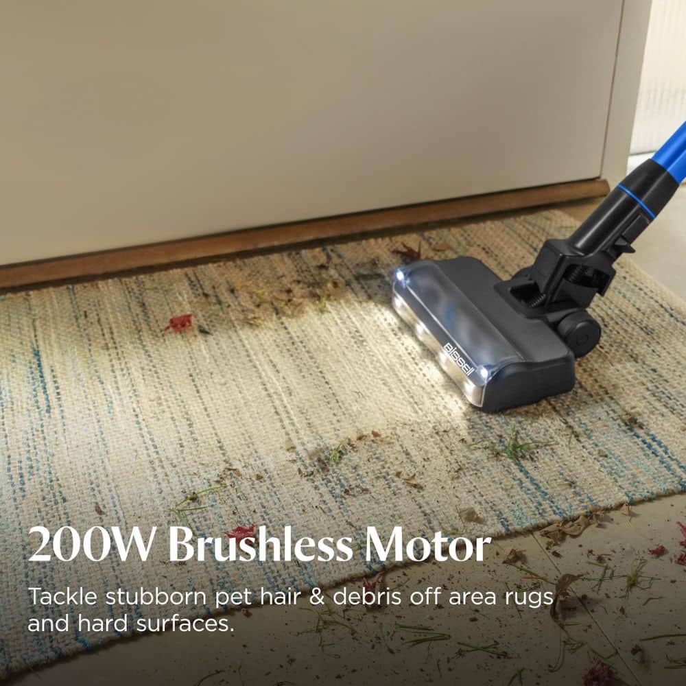 Vacuum cleaner head cleaning a rug with pet hair and debris; overlay text reads '200W Brushless Motor'.