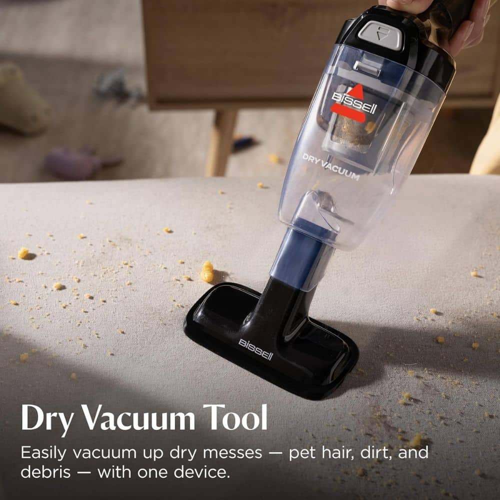 Dry vacuum tool attached to a handheld vacuum cleaning a mess on a tabletop surface.